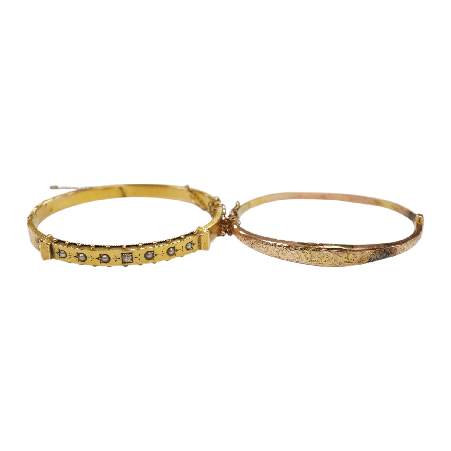 An Edwardian yellow metal, diamond and seed pearl set hinged bangle and one other late Victorian engraved 9ct gold hinged bangle, both a.f., gross weight 14.6 grams. Condition - poor